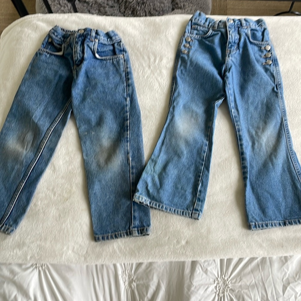 Girl jeans, size 5 one straight leg, one flare with three buttons on pockets.